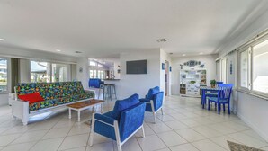 A spacious living area with a sofa, chairs, a coffee table, and a dining set. - 2 Mi to Englewood Beach! Home w/ Private Dock (Englewood)