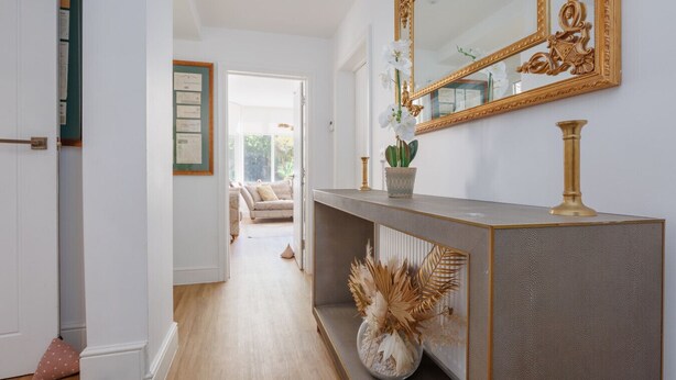 A hallway with a console table, a large mirror, and a potted plant. - Le Chambre d’Isabel - Close to shops, bars and places to eat & the beach (Dorset)