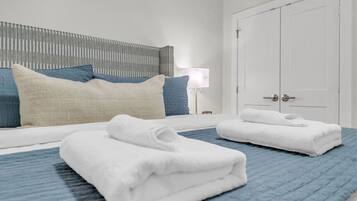 A hotel room with a bed, a nightstand, a lamp, and a wardrobe.