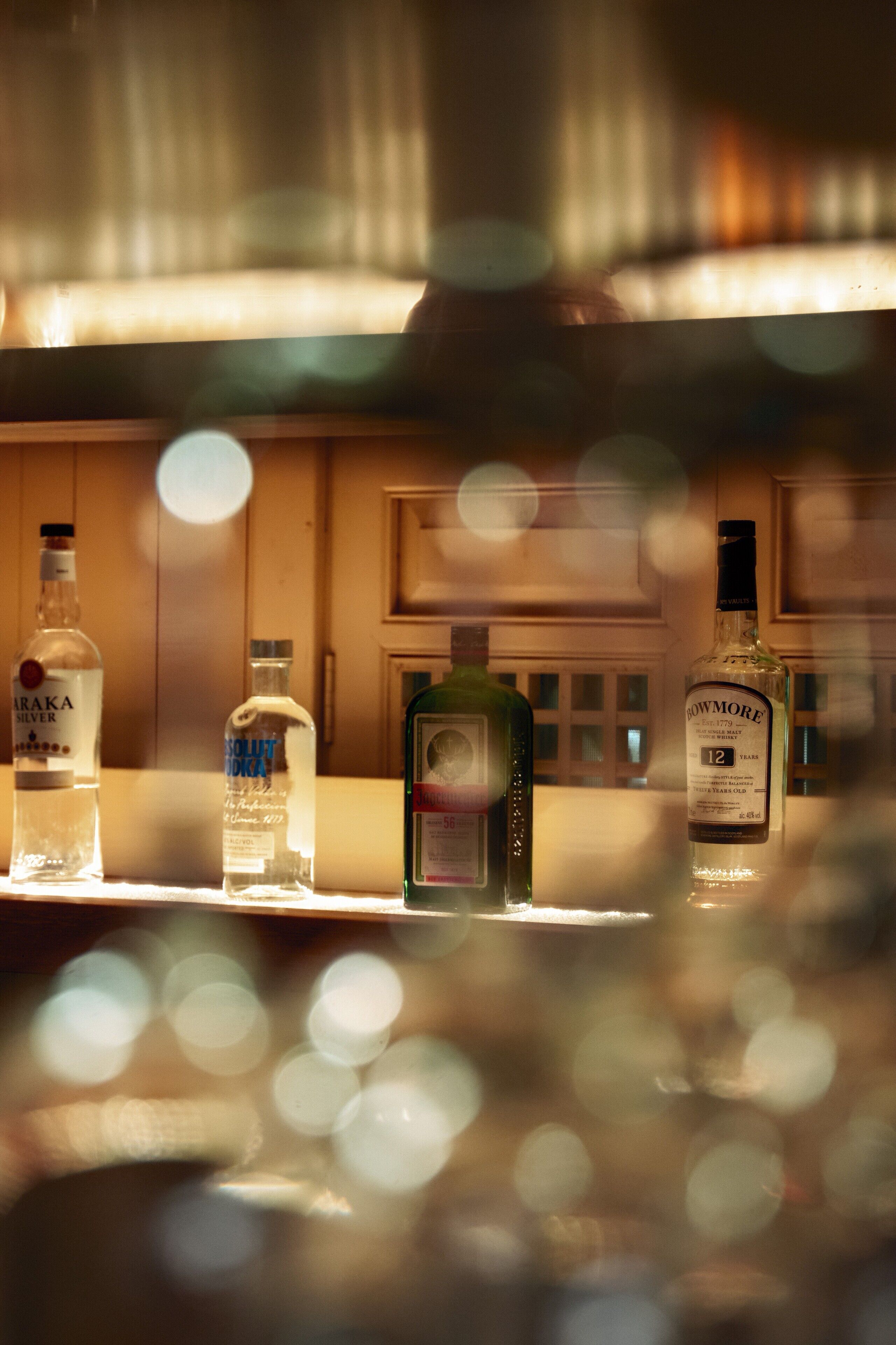 A bar area with bottles of liquor.