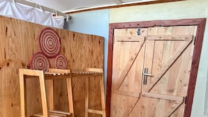 A wooden room with a wooden ladder shelf and a wooden door. - Amani Eserian Ngorongoro (Ngorongoro)