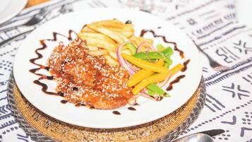 A plate of food with a patterned tablecloth.