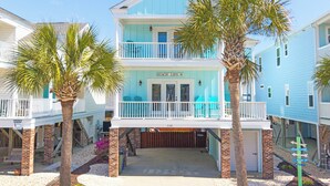 A two-story beachfront house with a balcony, palm trees, and a sign reading 'BEACH LIFE'. - 4 BR Beach House with a Private Pool! Beach Life (Surfside Beach)