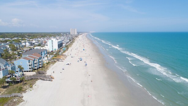 A coastal town with a wide sandy beach, beachfront properties, and a clear view of the ocean. - 4 BR Beach House with a Private Pool! Beach Life (Surfside Beach)