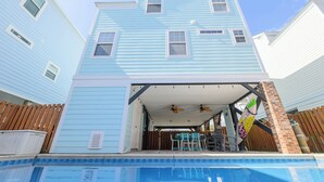 A two-story house with a covered patio area and a swimming pool. - 4 BR Beach House with a Private Pool! Beach Life (Surfside Beach)