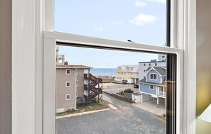 A residential street view through a window with a clear sky. - Updated 2 BR 2 BA Unit - 1/2 Block from the Beach (Ocean City)