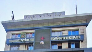 A multi-story building with various commercial establishments on the ground floor, including a pharmacy and a furniture store. - THE BULL GROUP INTERNATIONAL (Surat)