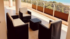 A balcony with wicker furniture and a view of the ocean. - Luxury Accommodation With Panoramic Terrace (Lignano Sabbiadoro)