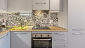 A kitchen with patterned backsplash, stainless steel appliances, and a wooden countertop. - A cozy and spacious 80 square meters apartment, perfect for four people, located on the first floor of a typical Sant'Antioco building (NO elevator).The property is located a short distance from the town center and offers quick access to the seafront. It (Sant'Antioco)