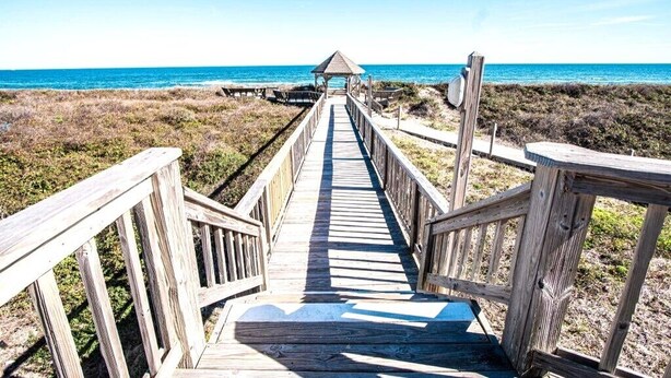 A wooden boardwalk leading to a beach with a gazebo at the end. - Beautiful 3BR Condo in OBX, NC, Beach, Pools, Hot Tub, Family Resort Aug. 9-15 (duck)