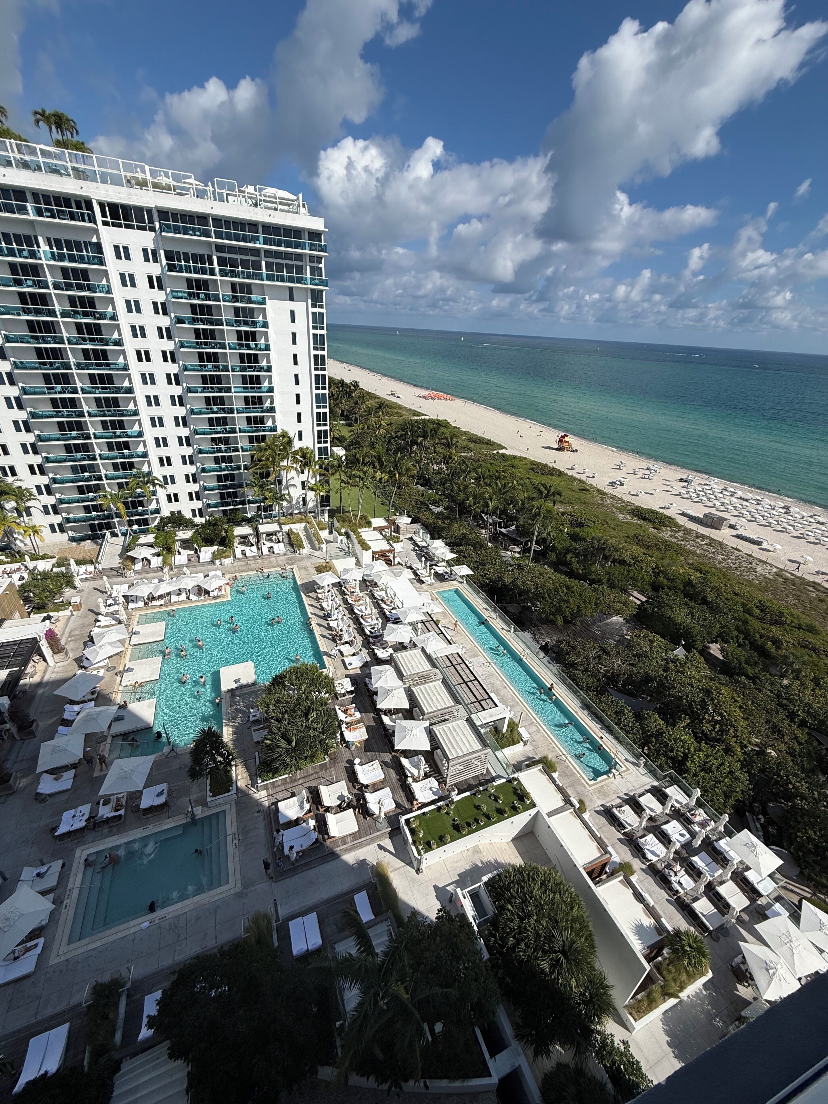 A hotel with a pool area, beach access, and a view of the ocean.