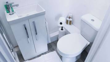 Shower, hair dryer, towels, shampoo