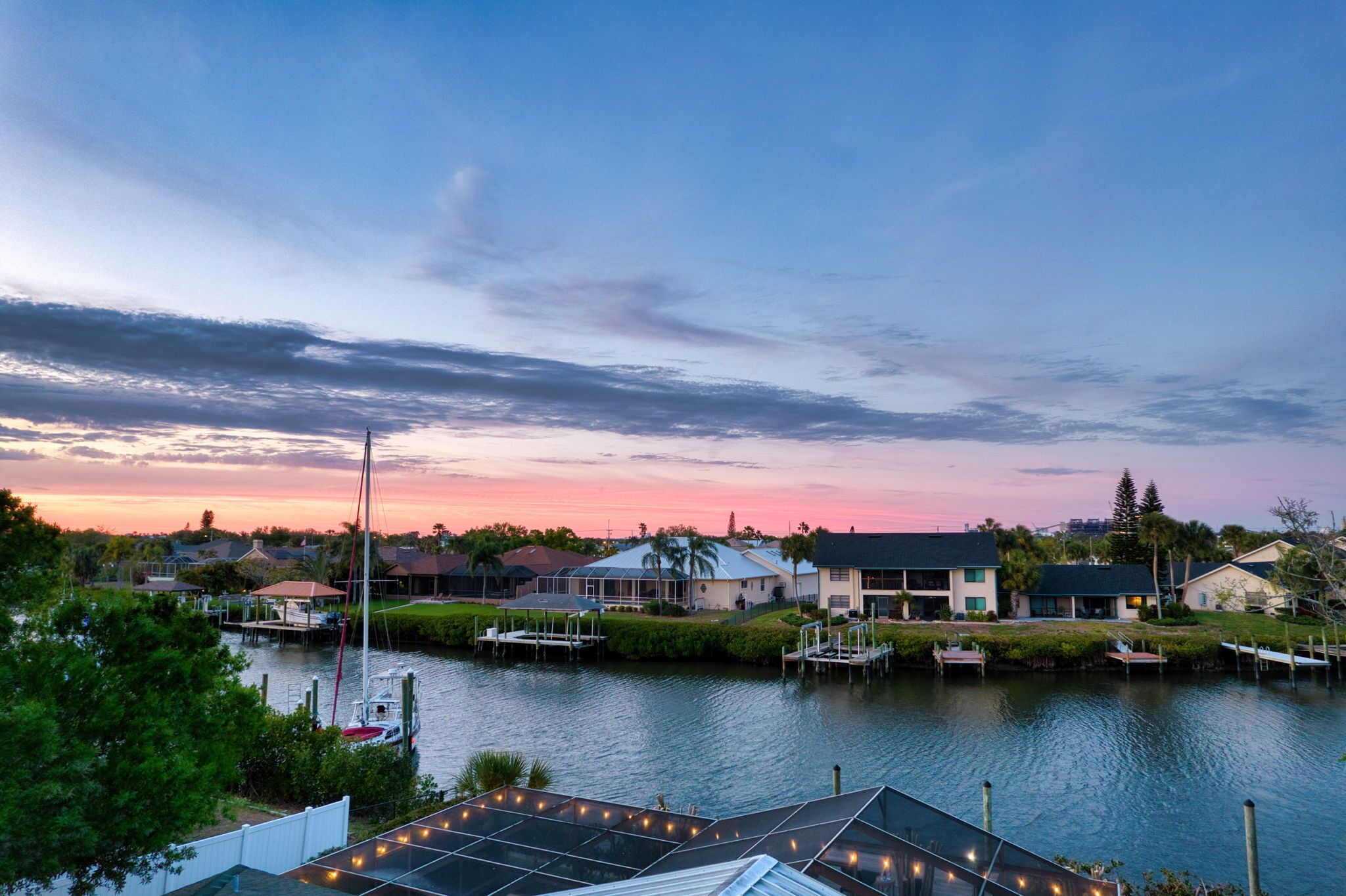 A waterfront property with houses, docks, and a marina.