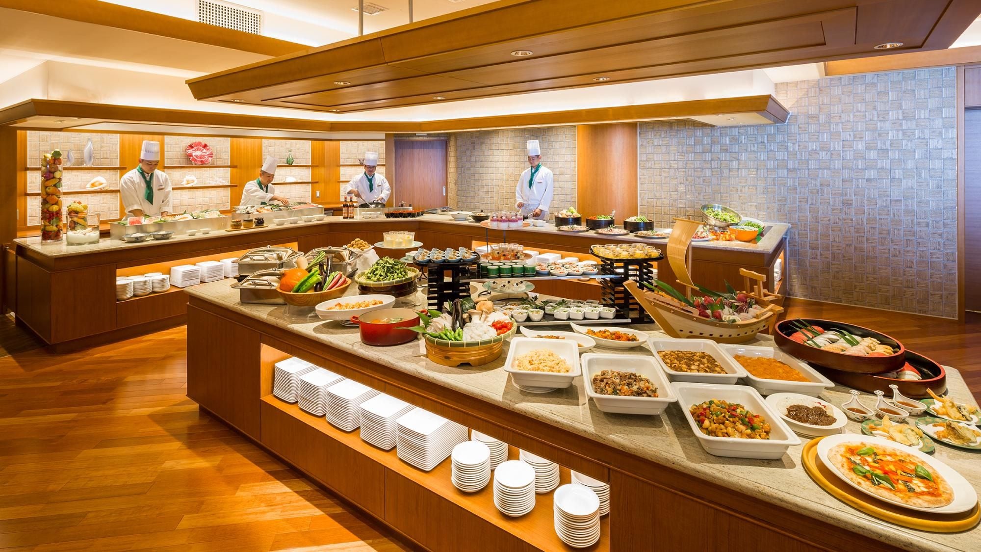 A buffet with various food items and a counter where staff are serving.