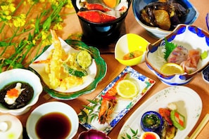 A variety of dishes on a table, including seafood, vegetables, and a bowl of soup. - Hirayama Onsen Okuyamaga Onsen Ryokan (Yamaga)