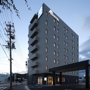 A multi-story hotel with a prominent 'AB HOTEL' sign, a covered entrance, and a parking area. - AB Hotel Seki (Seki)