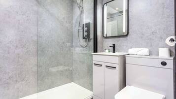 Shower, hair dryer, towels, shampoo