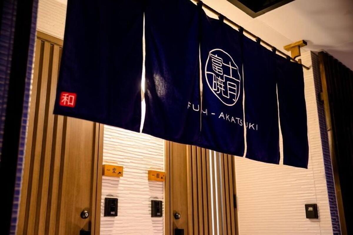 A room with a sliding door, a wall-mounted sign, and a wooden panel.