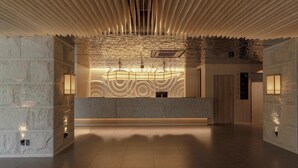 A modern lobby with a unique ceiling design, a reception desk, and wall-mounted lighting. - Hotel Yukari-no-mori Kawaguchiko (Fujikawaguchiko)