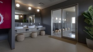A modern bathroom with a large mirror, two sinks, and a sliding glass door leading to a shower area. - Hotel Yukari-no-mori Kawaguchiko (Fujikawaguchiko)