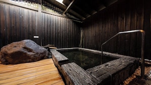 A hot spring bath with wooden walls and a wooden deck. - Nagomi Tsuki (Beppu)