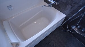A white bathtub with a handheld showerhead, a small control panel, and a drain. - Shirahama no Yado Daigo (Shirahama)
