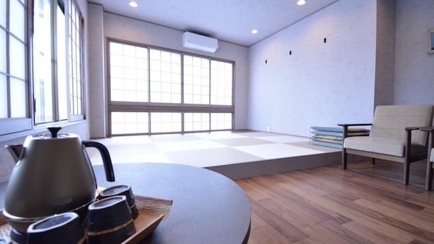 A room with a tatami mat floor, a tatami mat seating area, a low table with a kettle and cups, and a chair. - Shirahama no Yado Daigo (Shirahama)