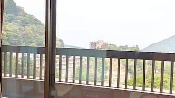 A room with a view of a mountainous landscape through large windows.