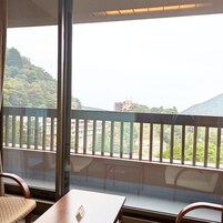 Una habitación con vistas a un paisaje montañoso a través de amplios ventanales.