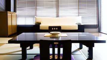 A modern interior with a sofa, a dining table, and a chair.