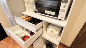 A kitchen with a microwave, coffee maker, and a drawer with dishes. - Point Vacation Kaga Yamanaka (Kaga)