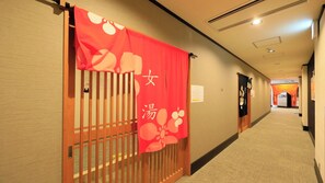 A hotel corridor with a wooden gate, a red curtain with Japanese characters, and a carpeted floor. - Point Vacation Kaga Yamanaka (Kaga)