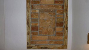 A wall with a brick pattern. - Vasilis Ios Place Room 1 (Chora)