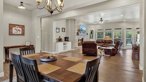 A spacious living area with a dining table, sofas, and a fireplace. - Crazy Horse-Close to Canyon Lake Marina! (Canyon Lake)