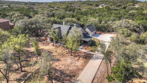 A residential area with a house featuring a sloped roof and a covered patio area. - Crazy Horse-Close to Canyon Lake Marina! (Canyon Lake)