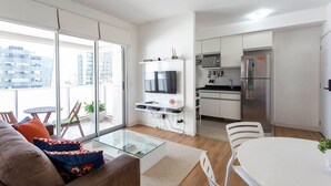 A modern apartment with a living area, kitchen, and balcony. - ADD Berrini (São Paulo)