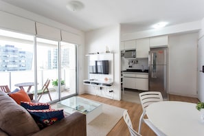 A modern apartment with a living area, kitchen, and balcony. - ADD Berrini (São Paulo)