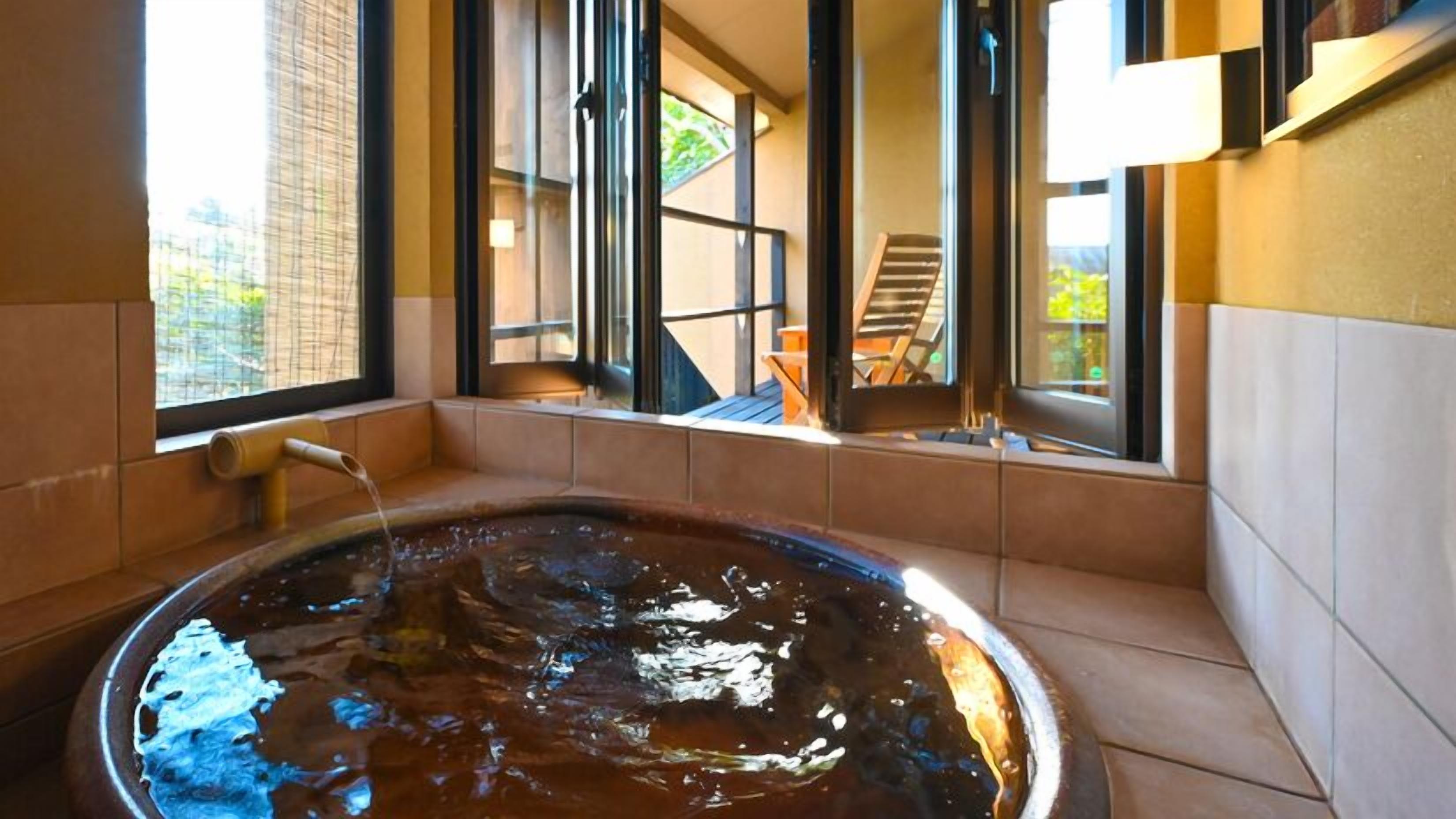 A hot tub with a view of a deck and outdoor area.
