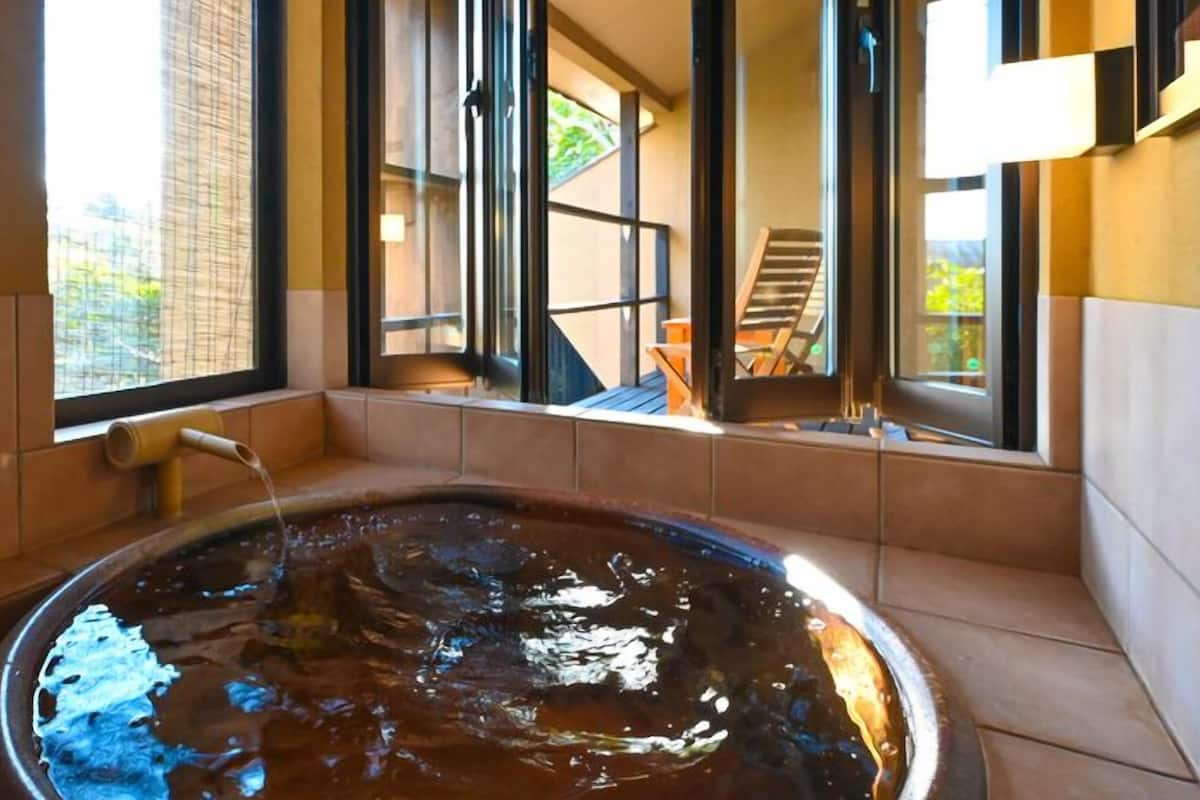 A hot tub with a view of a deck and outdoor area.