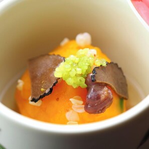 A dessert in a white cup with a caramelized top, a piece of fruit, and a garnish. - Kurokawa Onsen Iyashi no Sato Kiyashiki (Minamioguni)