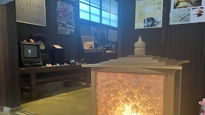 A traditional Japanese room with tatami flooring, a low wooden table, a television, and a decorative paper lantern. - Oyado Sakura Gojo Station (Gojo)