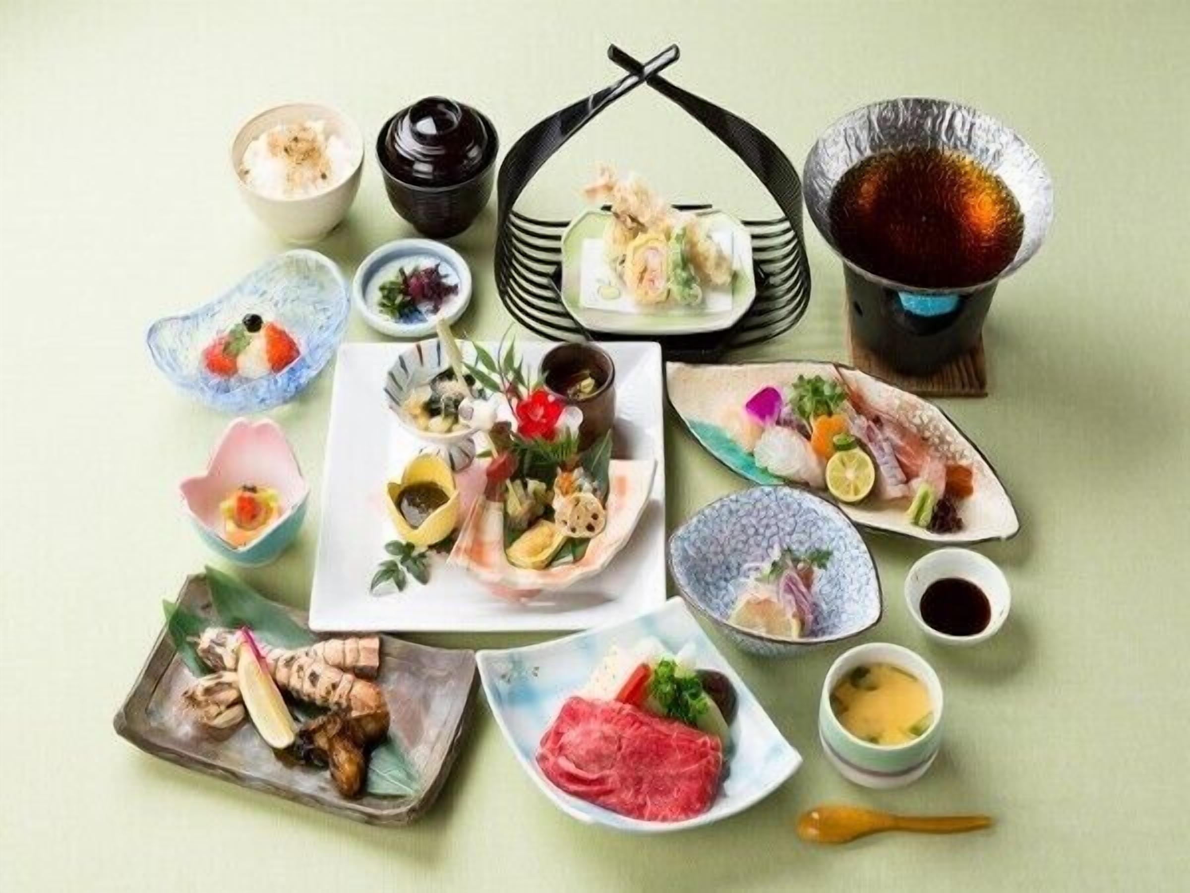 A variety of Japanese dishes and drinks arranged on a table.