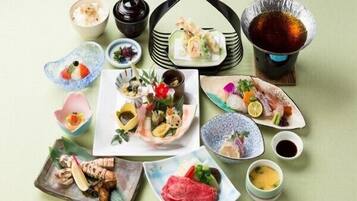 A variety of Japanese dishes and drinks arranged on a table.