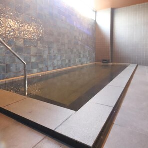 A rectangular indoor pool with a tiled wall and a metal handrail on one side. - AB Hotel Iga Ueno (Iga)
