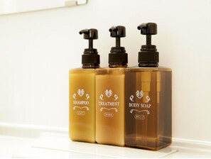 Three bottles of liquid soap with pump dispensers on a white surface. - AB Hotel Iga Ueno (Iga)