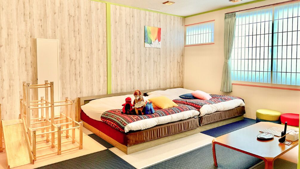 Ein Zimmer mit zwei Betten, einem Schreibtisch, einem Stuhl, einem Fenster mit Blick und einer Holzwand.