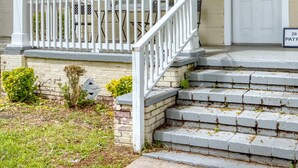 A two-story house with a white porch, a front door with a wreath, and a mailbox. - Near Chattahoochee River & Shops - Central Duplex (Columbus)
