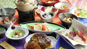 A variety of dishes on a table with a floral tablecloth.