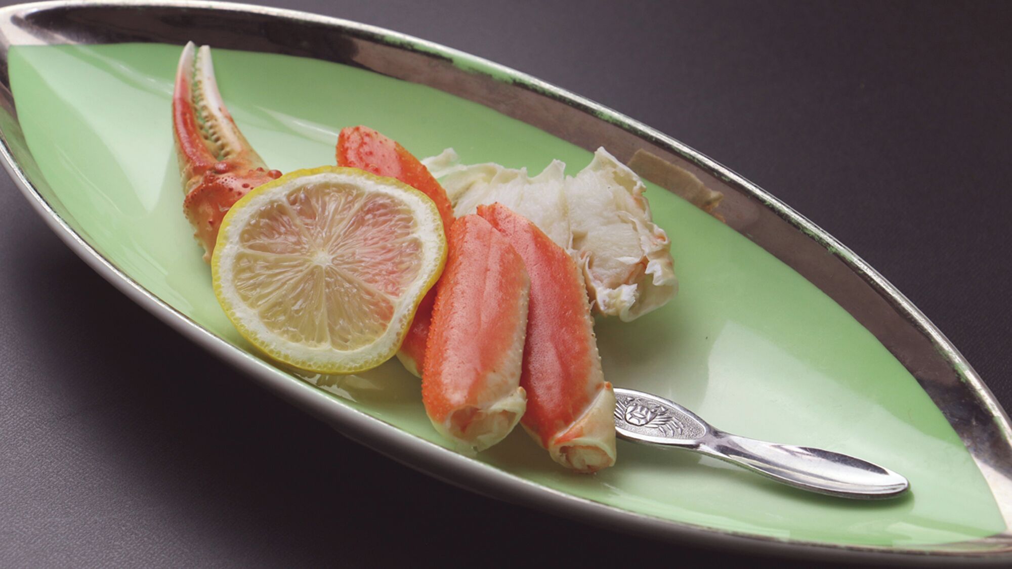 A plate with seafood and a lemon slice.