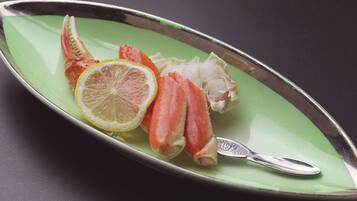 A plate with seafood and a lemon slice.